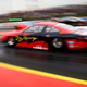 A photo of a drag racer on the track.